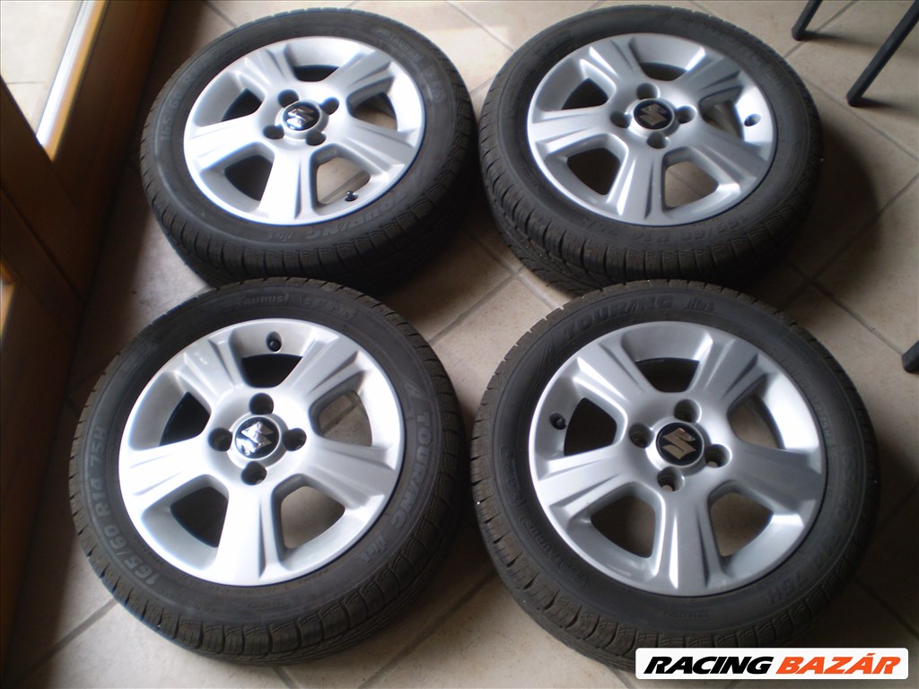  4x100 lyukosztású 14" újszerű alufelni, rajta 165/60 újszerű Taurus nyári gumi 1. kép