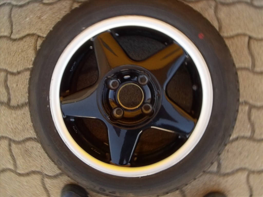  4x100 lyukosztású 14" használt Titan alufelni, rajta 165/60 használt Firestone nyári gumi gumi  2. kép